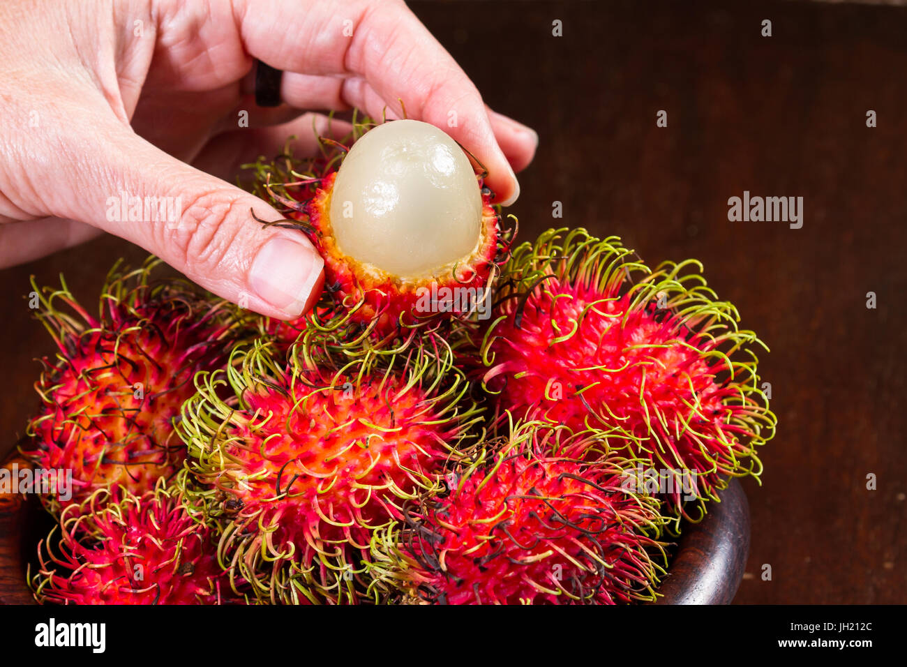 Holding rambutan hi-res stock photography and images - Alamy