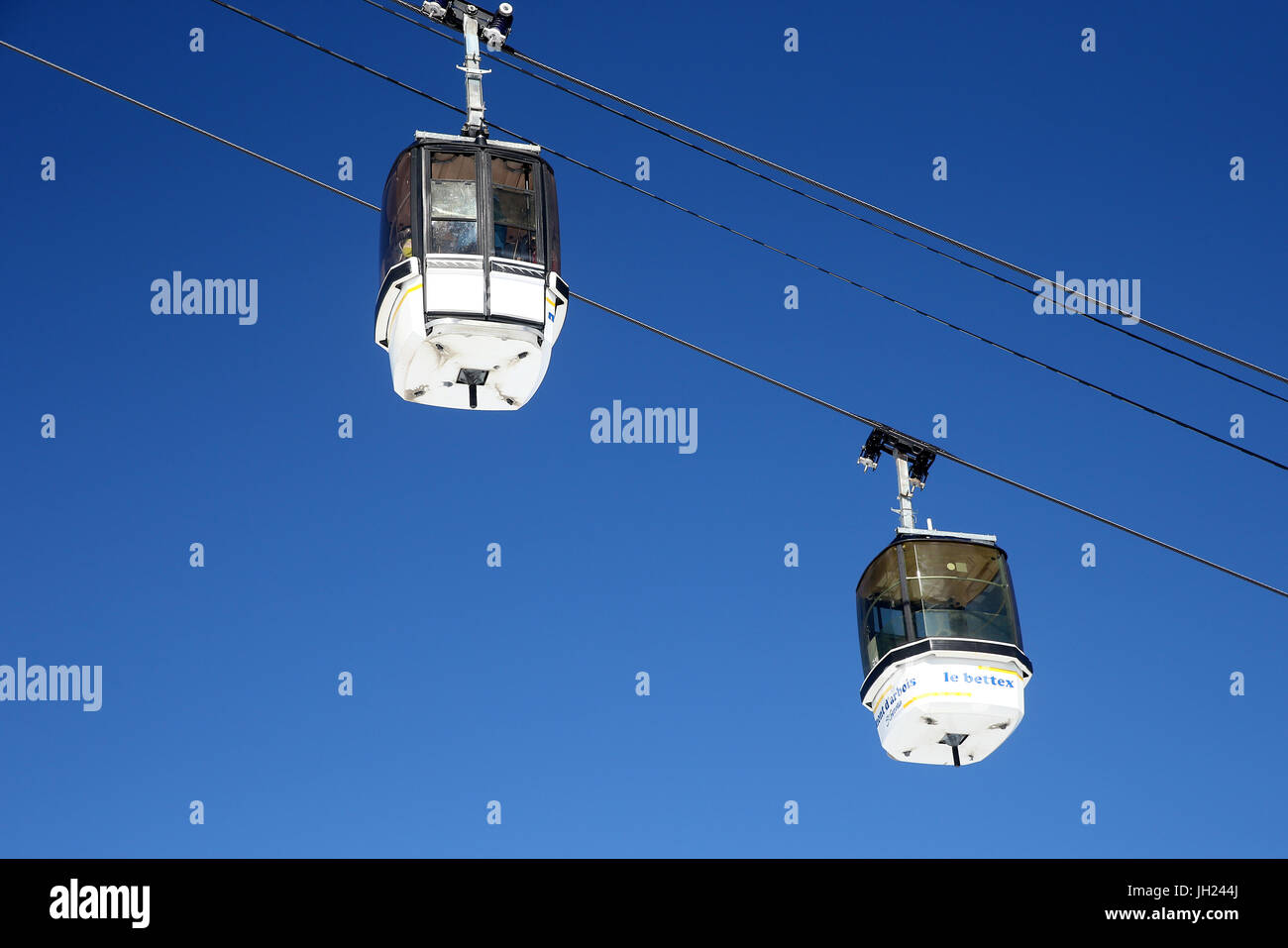 French Alps.  Skiing And Overhead Cable Car. France. Stock Photo