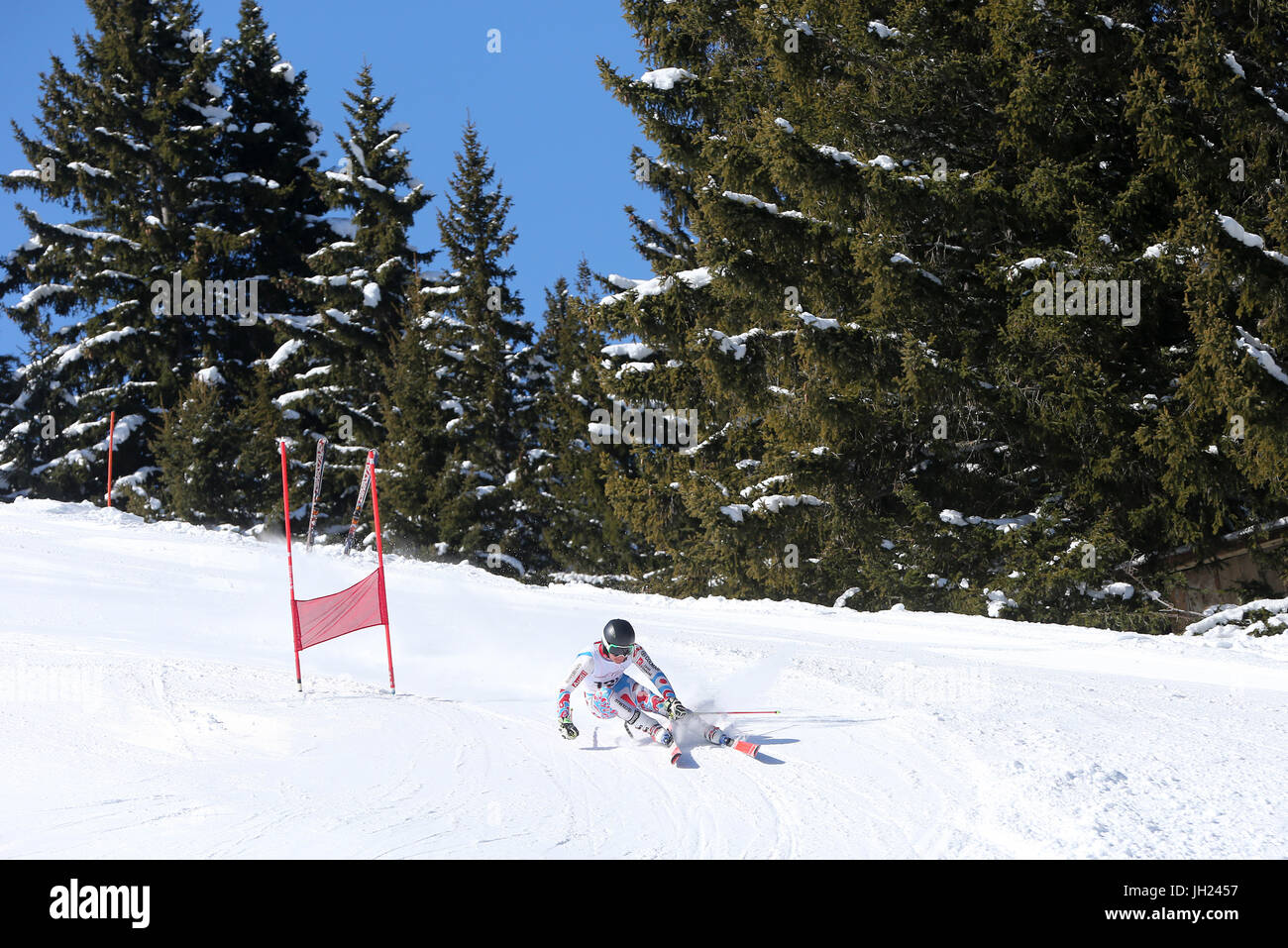 French Alps.  Giant Slalom skier rounds gate at high speed.  France. Stock Photo