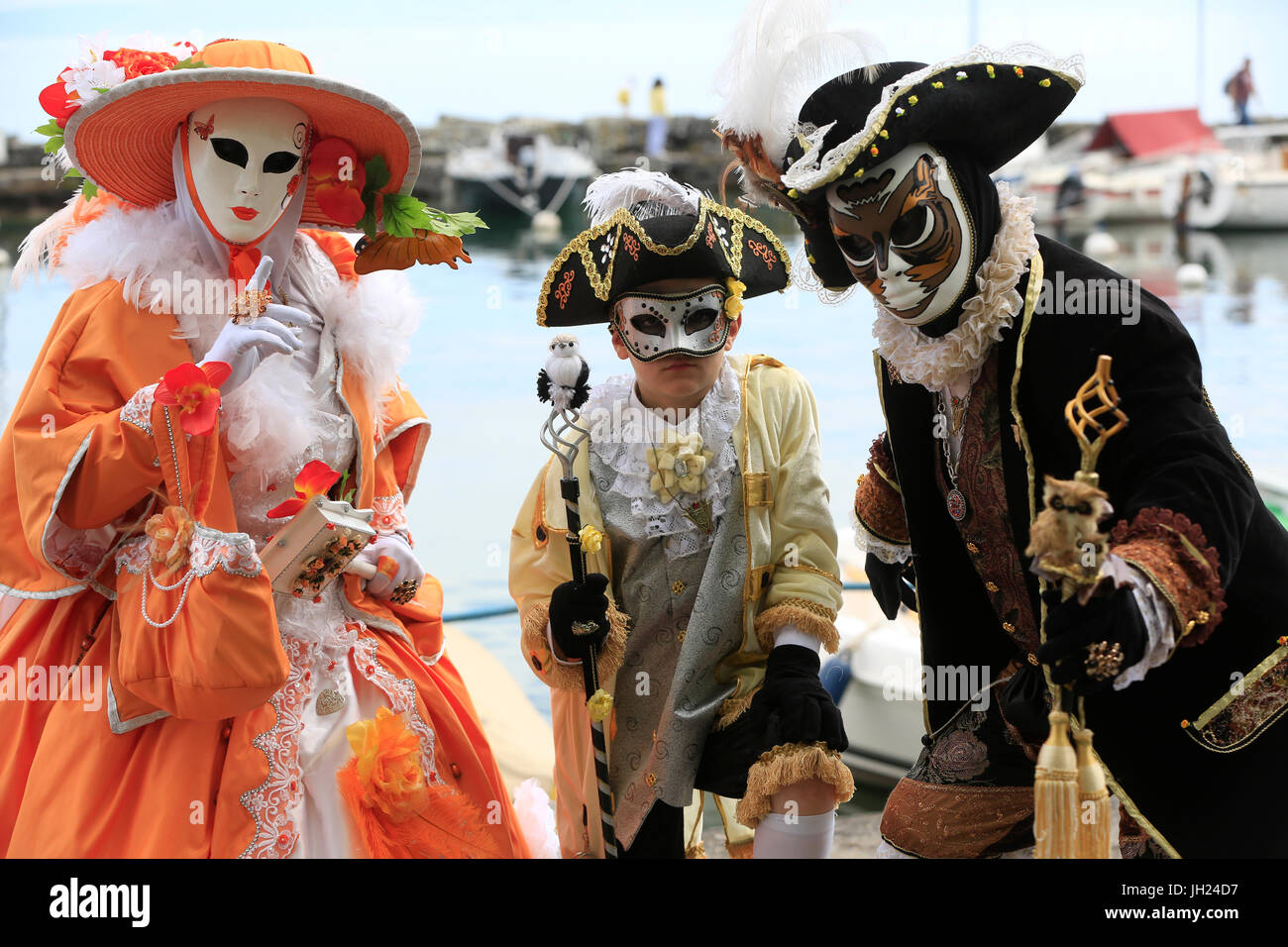 Yvoire, labelled Les Plus Beaux Villages de France (The Most Beautiful Villages of France). The Venitian carnival.  Family wearing carnival costume. Stock Photo