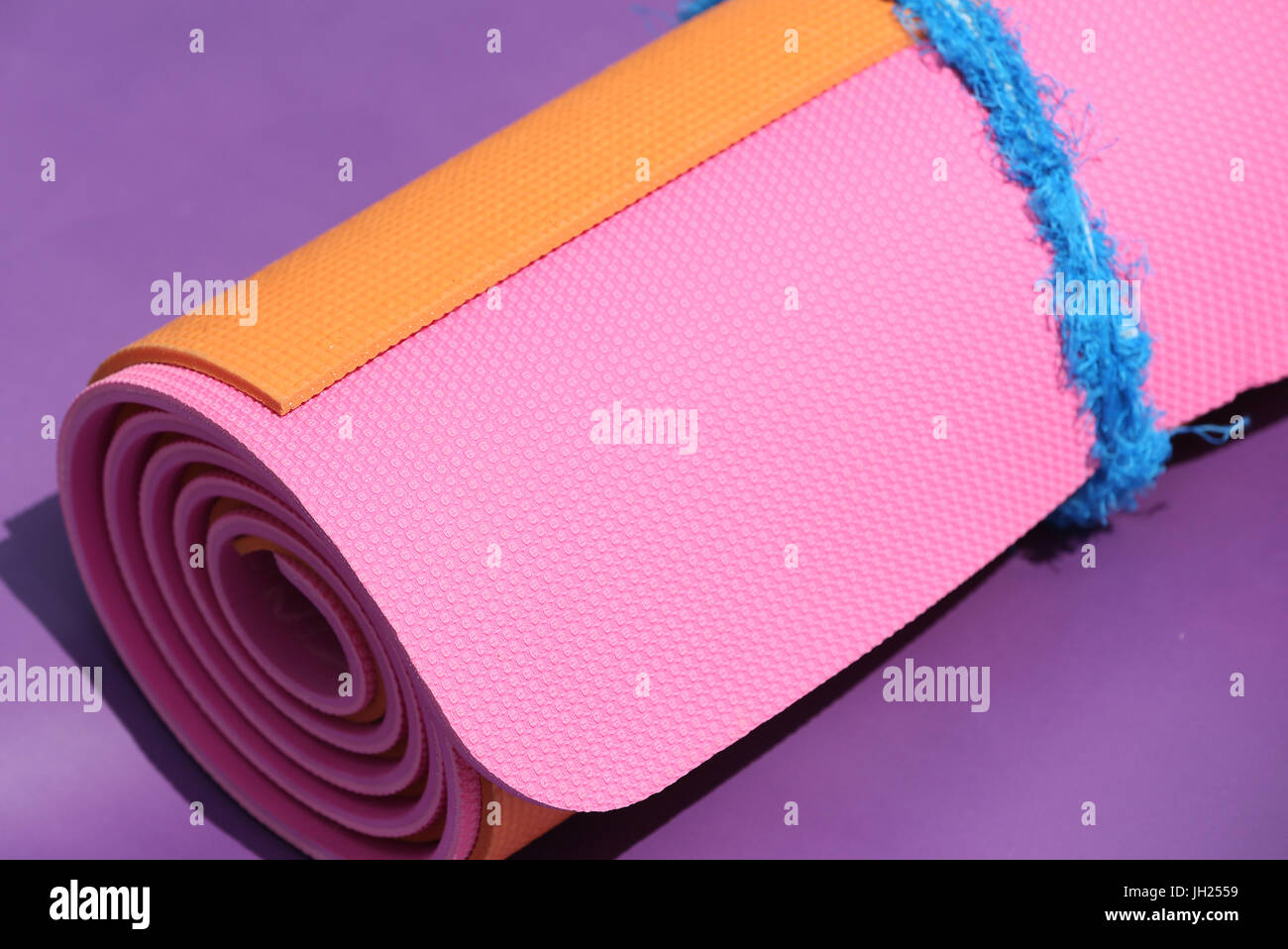Rolled up pink yoga mat. France Stock 
