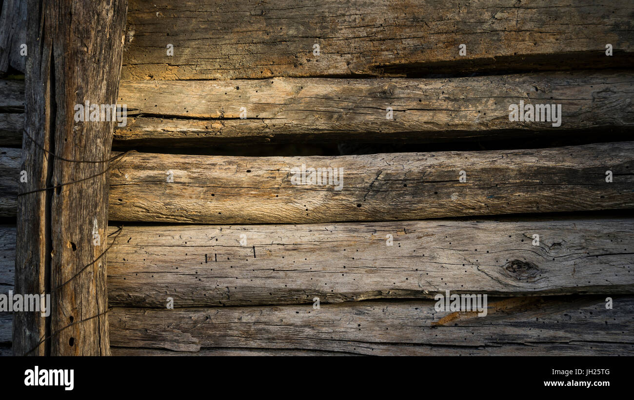 wall of old planks of building a barn to store hay in a farmhouse Stock Photo