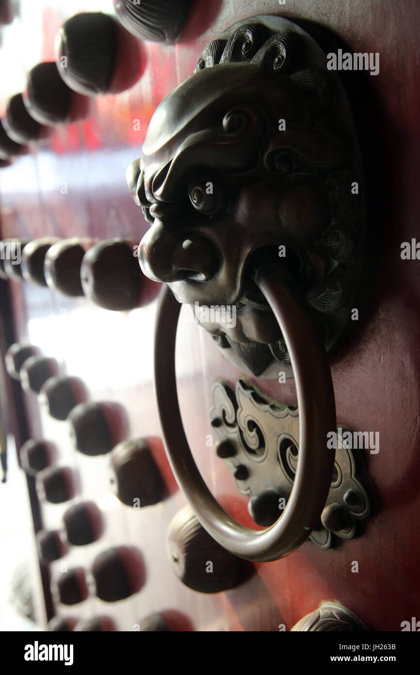 Buddha Tooth Relic Temple in Chinatown. Traditional red chinese door with a lion handle.  Singapore. Stock Photo