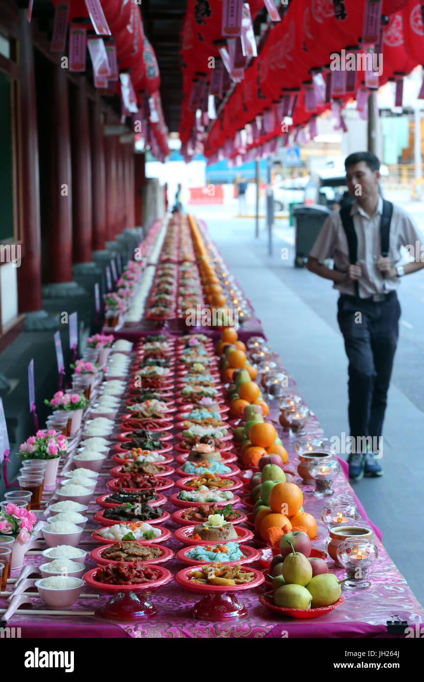 Buddha Tooth Relic Temple in Chinatown. Ullambana ceremony. Food is offered to the ancestors during the annual Ghost Festival. Singapore. Stock Photo