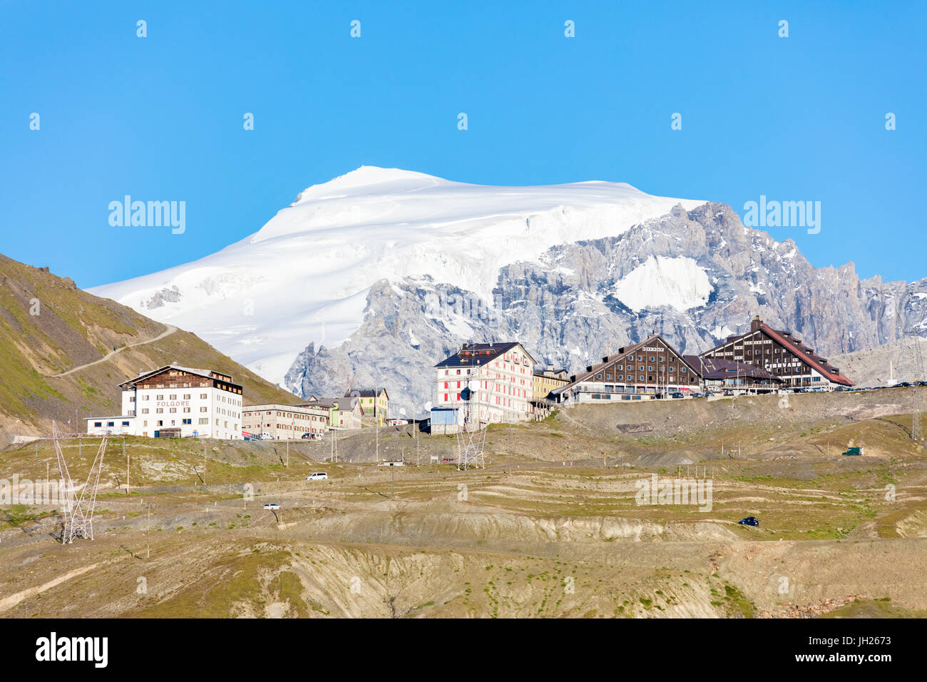 Blue sky frames the snowy peak of Mount Ortles at Stelvio Pass, Valtellina, Lombardy, Italy, Europe Stock Photo