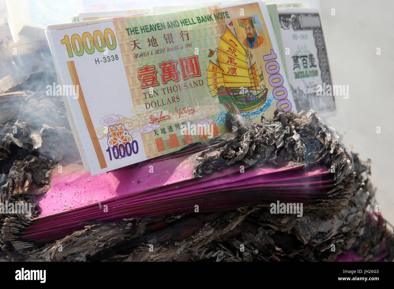 Hungry Ghost Festival (Ullambana). Ancestor worship.  Burning hell bank notes and other forms of joss paper. Singapore. Stock Photo