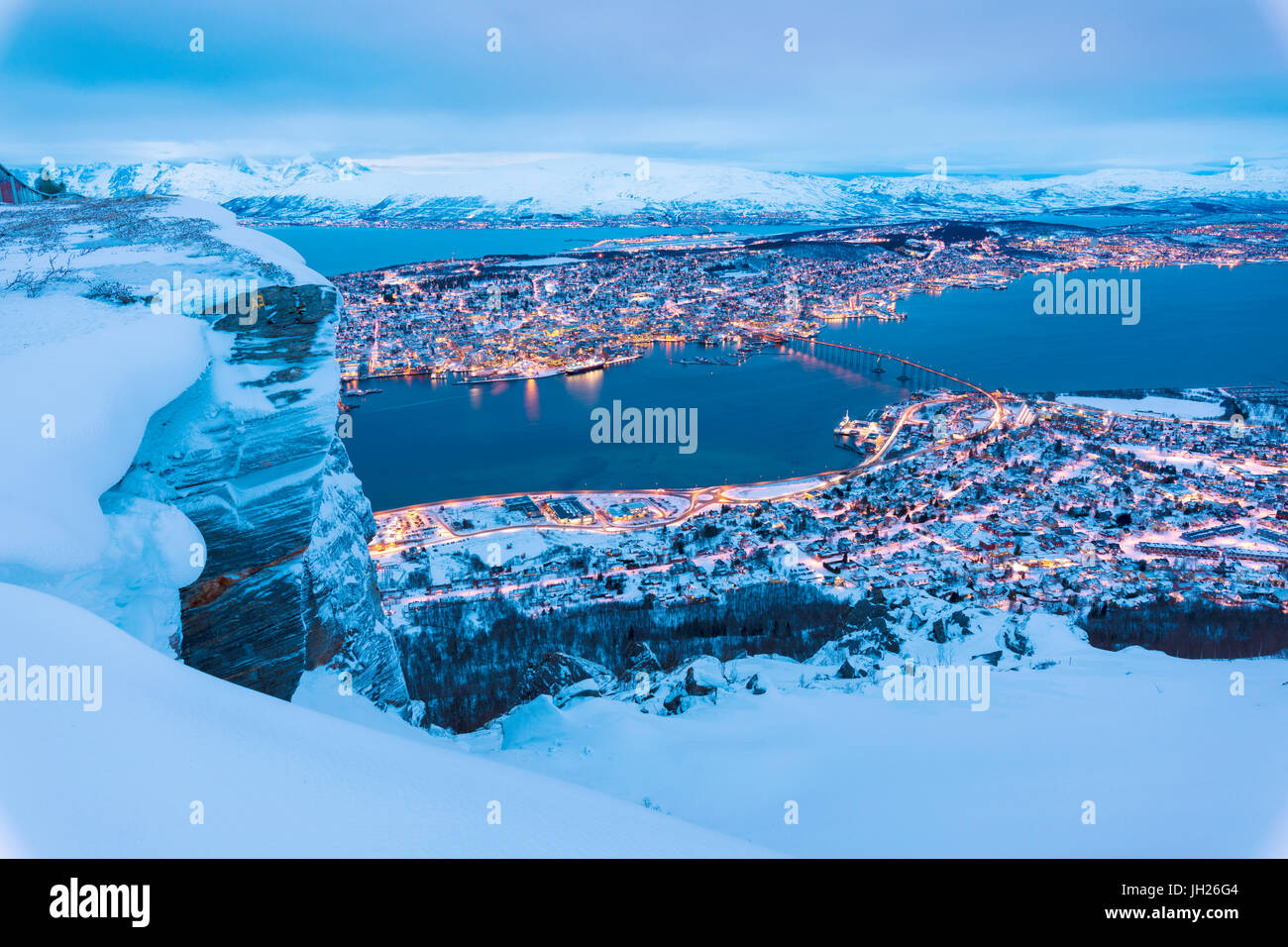 View of the city of Tromso at dusk from the mountain top reached by the Fjellheisen cable car, Troms, Northern Norway Stock Photo