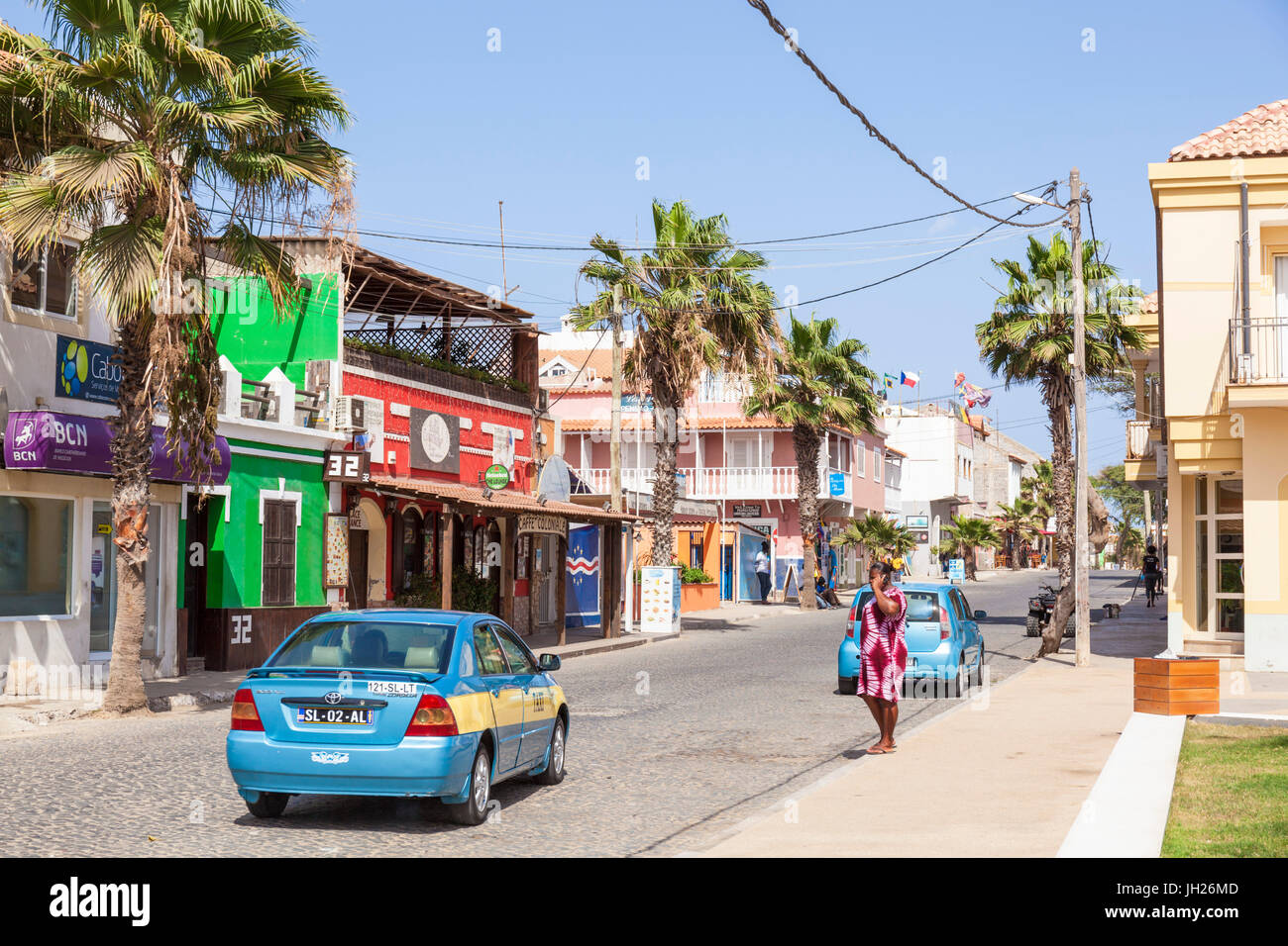 Local taxi driving down the main street, Rua 1 de Junho, Praca Central, Santa Maria, Sal island, Cape Verde, Africa Stock Photo