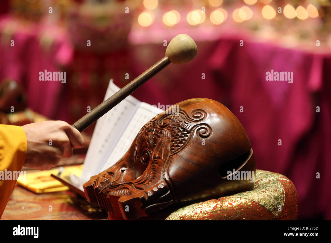 Buddha Tooth Relic Temple in Chinatown. Buddhist ceremony. Monk playing ...