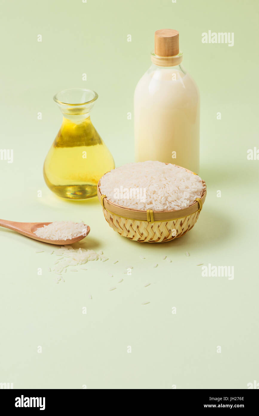 Rice oil in bottle glass and milk over green background Stock Photo - Alamy