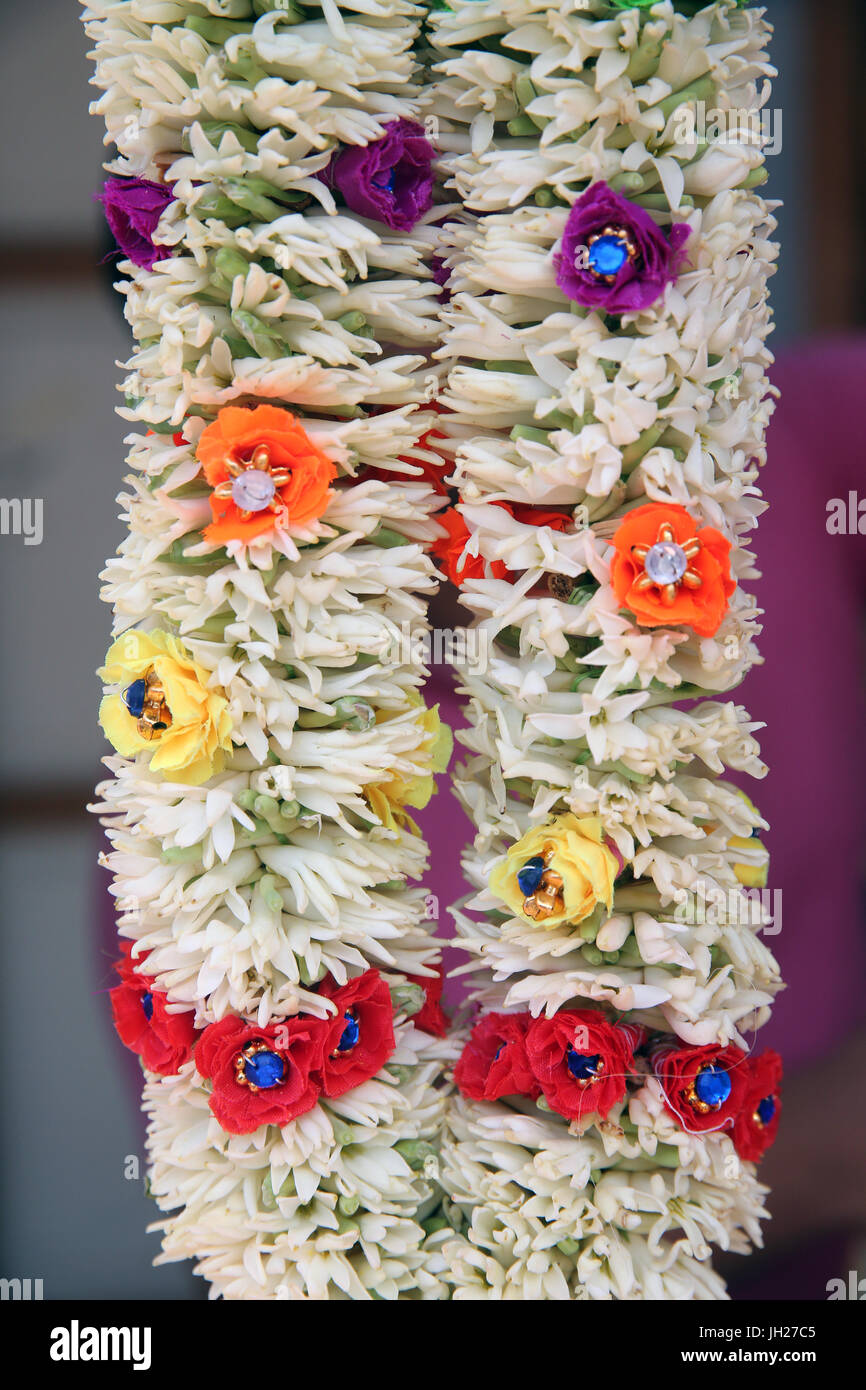 Selling flowers, coconuts and other offerings for the morning puja ceremony  Singapore. Stock Photo