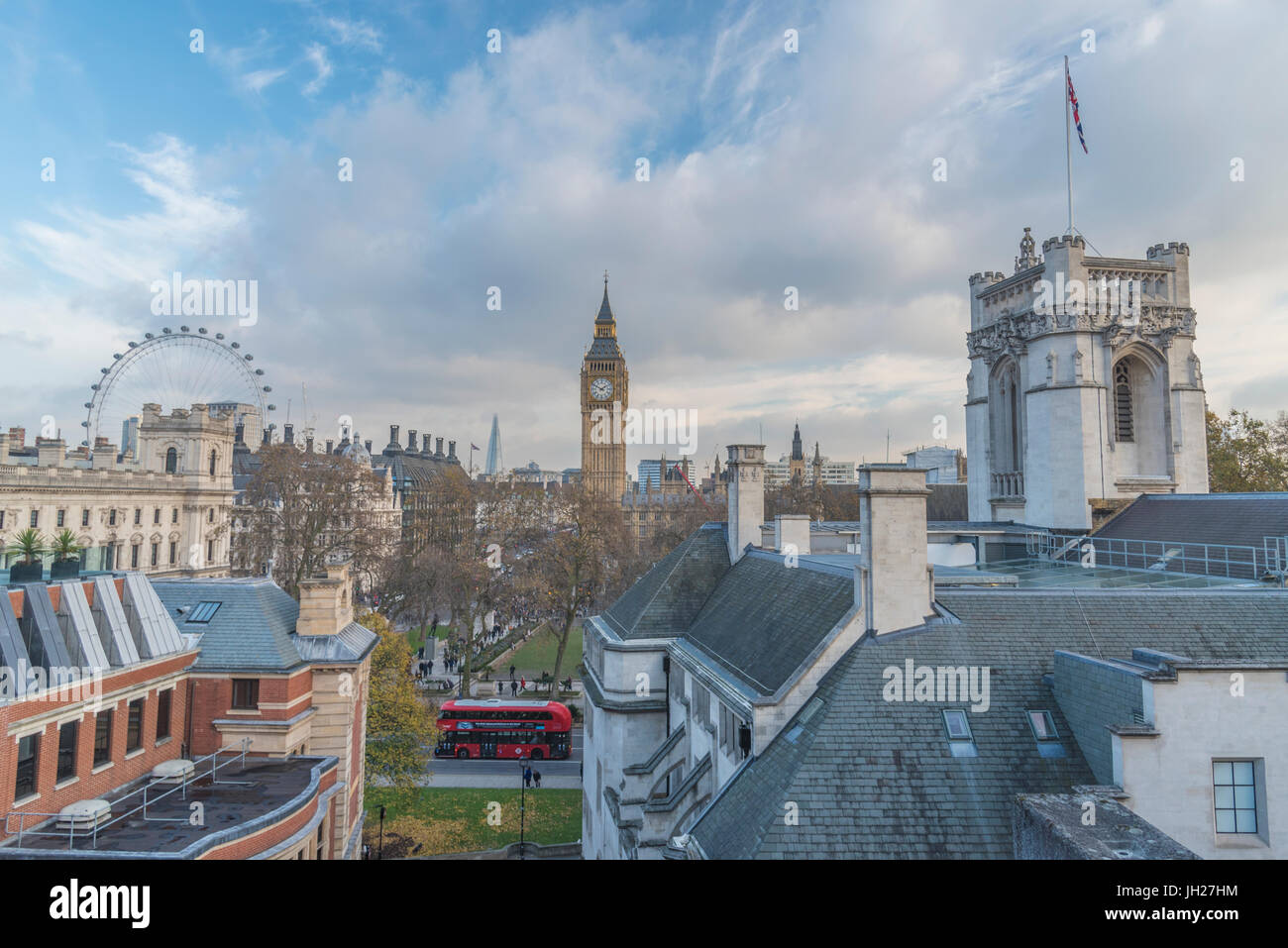 A London bus navigating Westminster with a beautiful blue sky above, London, England, United Kingdom, Europe Stock Photo
