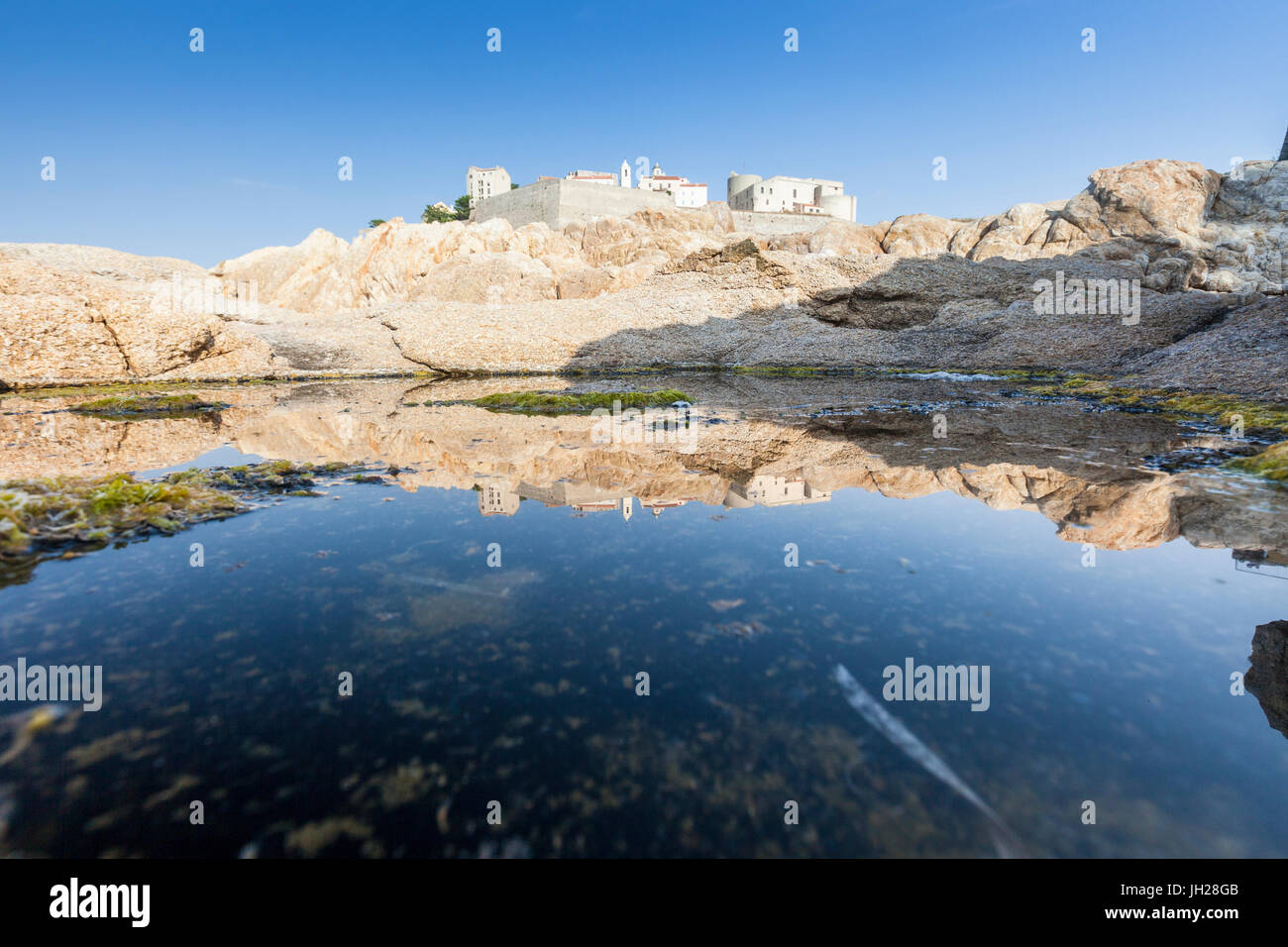 The ancient fortified citadel reflected in the blue sea, Calvi, Balagne Region, Corsica, France, Mediterranean, Europe Stock Photo