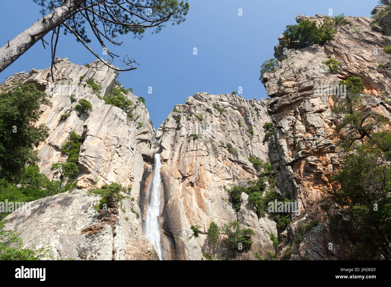 Blue sky frames The Piscia di Gallo waterfall surrounded by granite rocks, Zonza, Southern Corsica, France, Europe Stock Photo