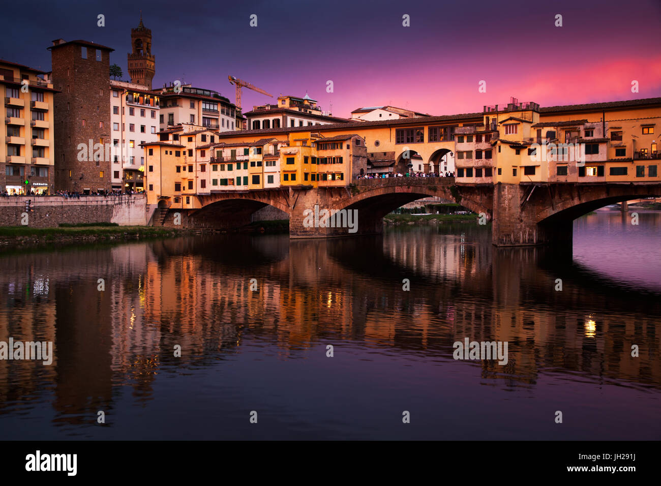 Ponte Vecchio at sunset reflected in the River Arno, Florence, UNESCO World Heritage Site, Tuscany, Italy, Europe Stock Photo