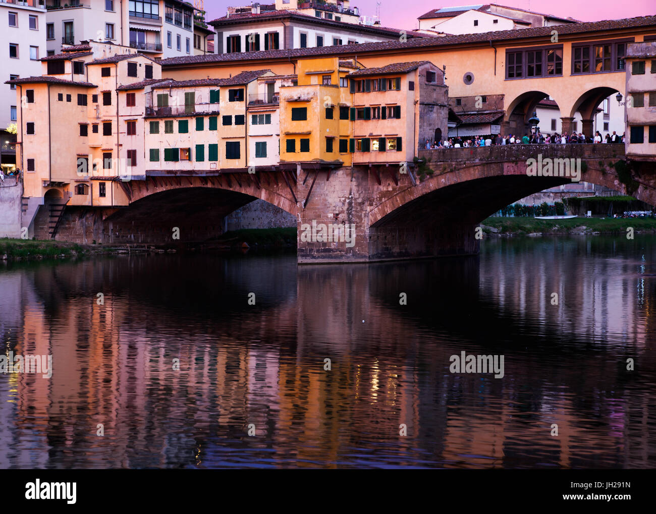 Ponte Vecchio at sunset reflected in the River Arno, Florence, UNESCO World Heritage Site, Tuscany, Italy, Europe Stock Photo