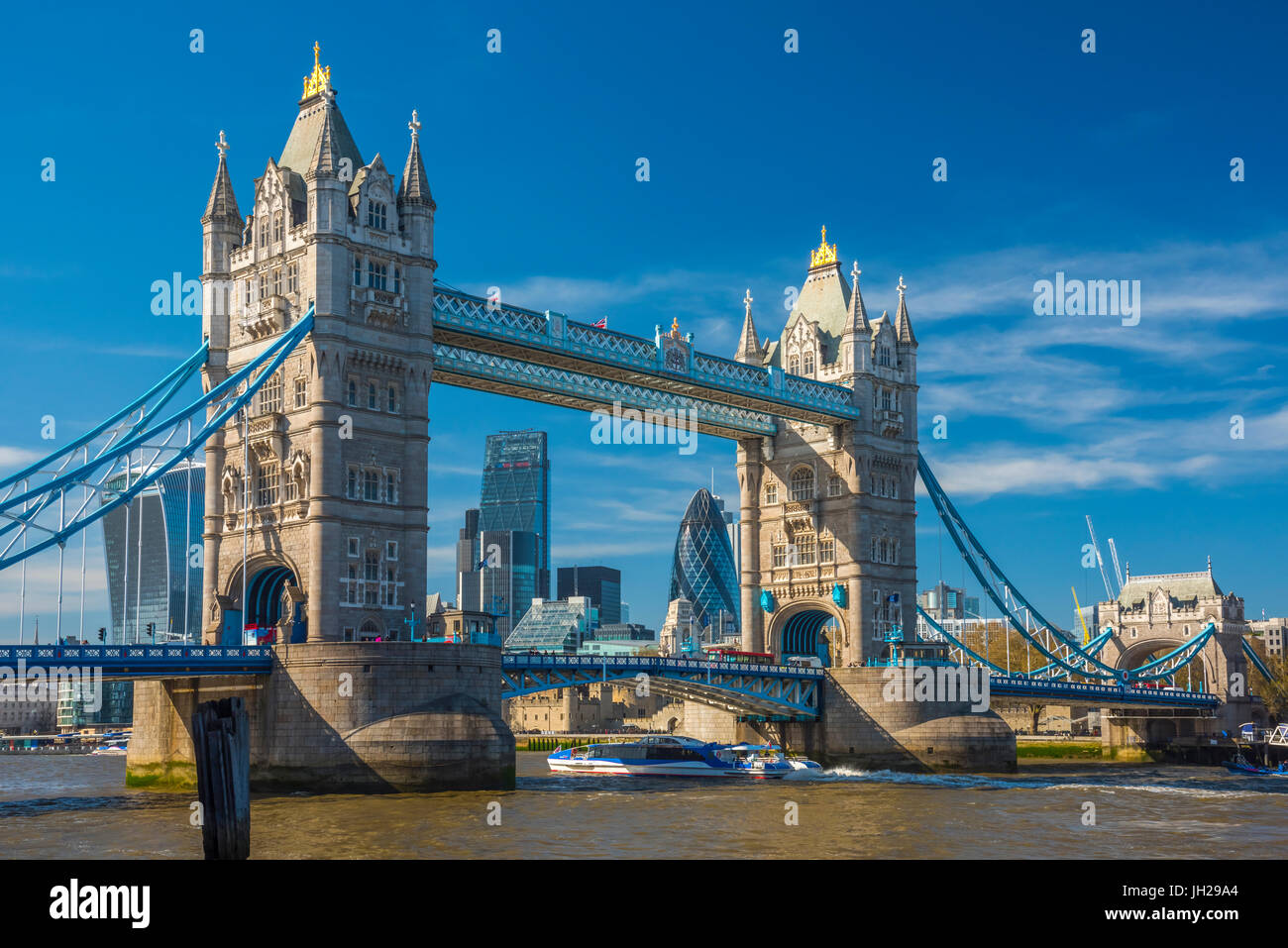 Tower Bridge over River Thames, City skyline including Cheesegrater and Gherkin skyscrapers beyond, London, England, UK Stock Photo