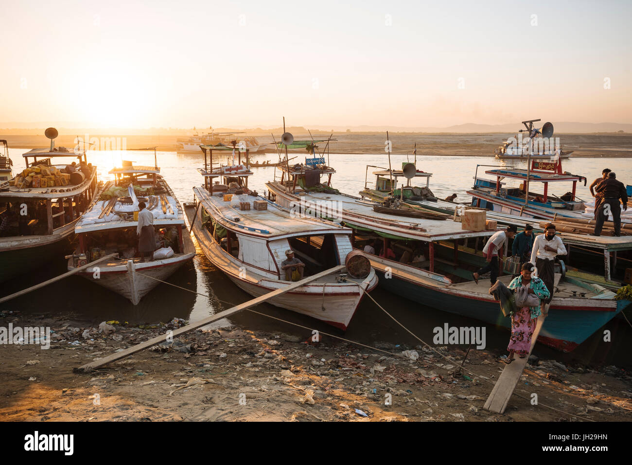 People unloading cargo from boats at Mayan Gyan Jetty, Ayeyarwady River ...