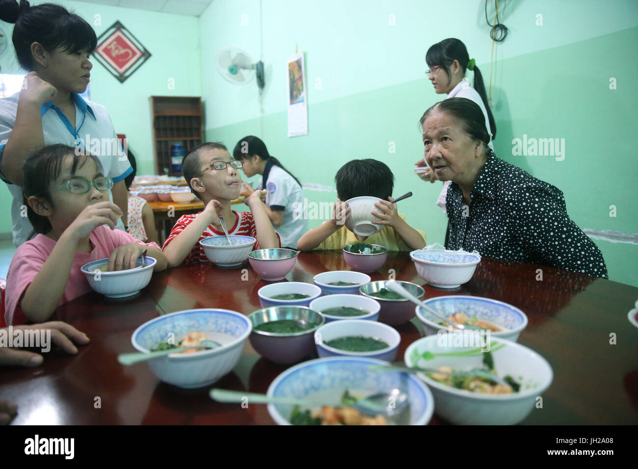 Vietnam.  Center for blind children.  Lunch.  Sister Elisabeth (Franciscan sisters) ensure the smooth running of the centre. Stock Photo
