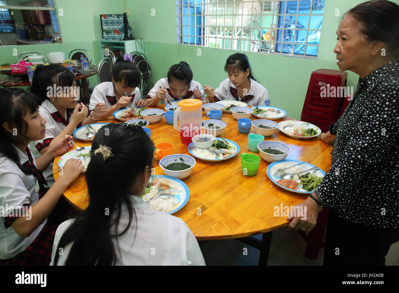 Vietnam.  Center for blind children.  Lunch.  Sister Elisabeth (Franciscan sisters) ensure the smooth running of the centre. Stock Photo
