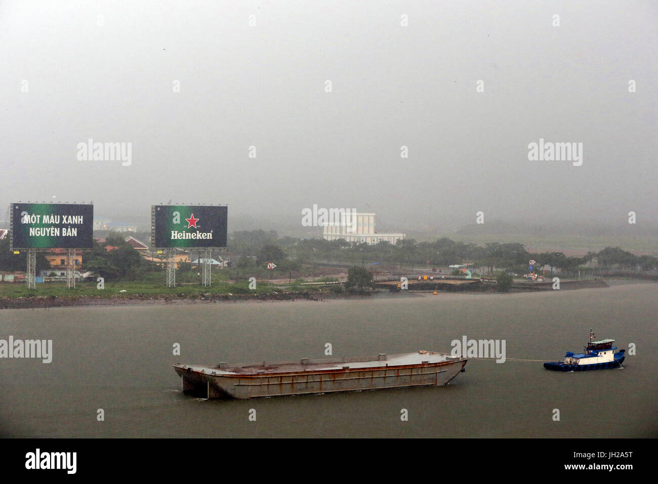 Vietnam, Ho Chi Minh City, ship on Saigon River during Heavy Monsoon Rain.  Ho Chi Minh City. Vietnam. Stock Photo