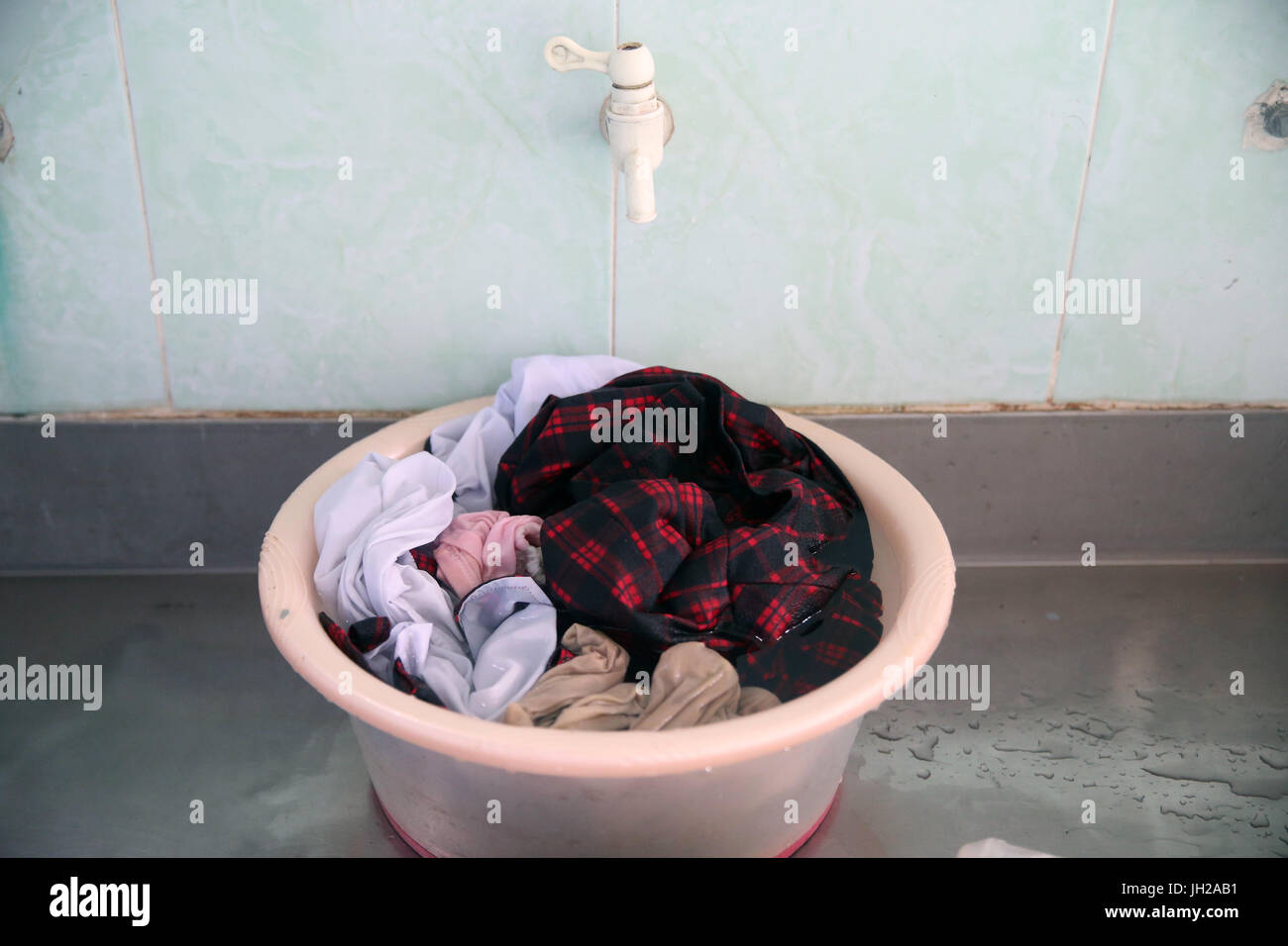 Wash basin full of clothes. Ho Chi Minh City. Vietnam. Stock Photo