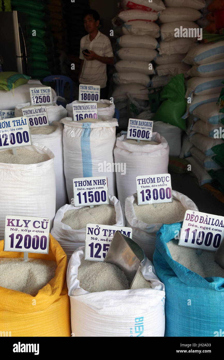 Rice in different qualities for sale in bags at an open air market.  Vietnam. Stock Photo