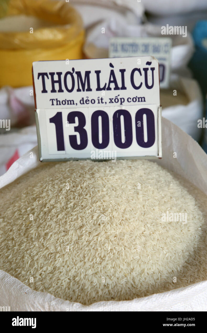 Rice in different qualities for sale in bags at an open air market.  Vietnam. Stock Photo