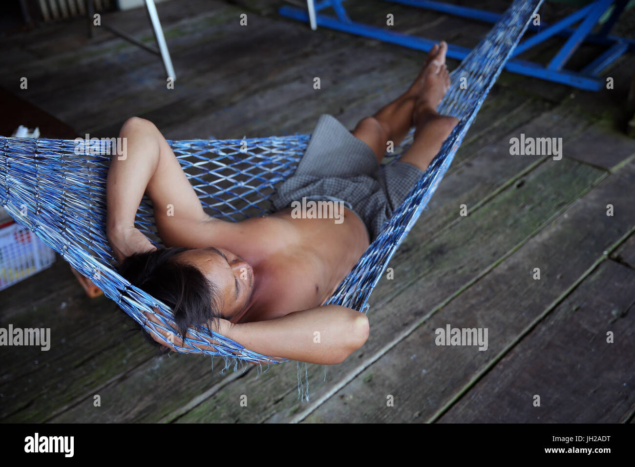 Man sleeping in a Hammock.  Vietnam. Stock Photo