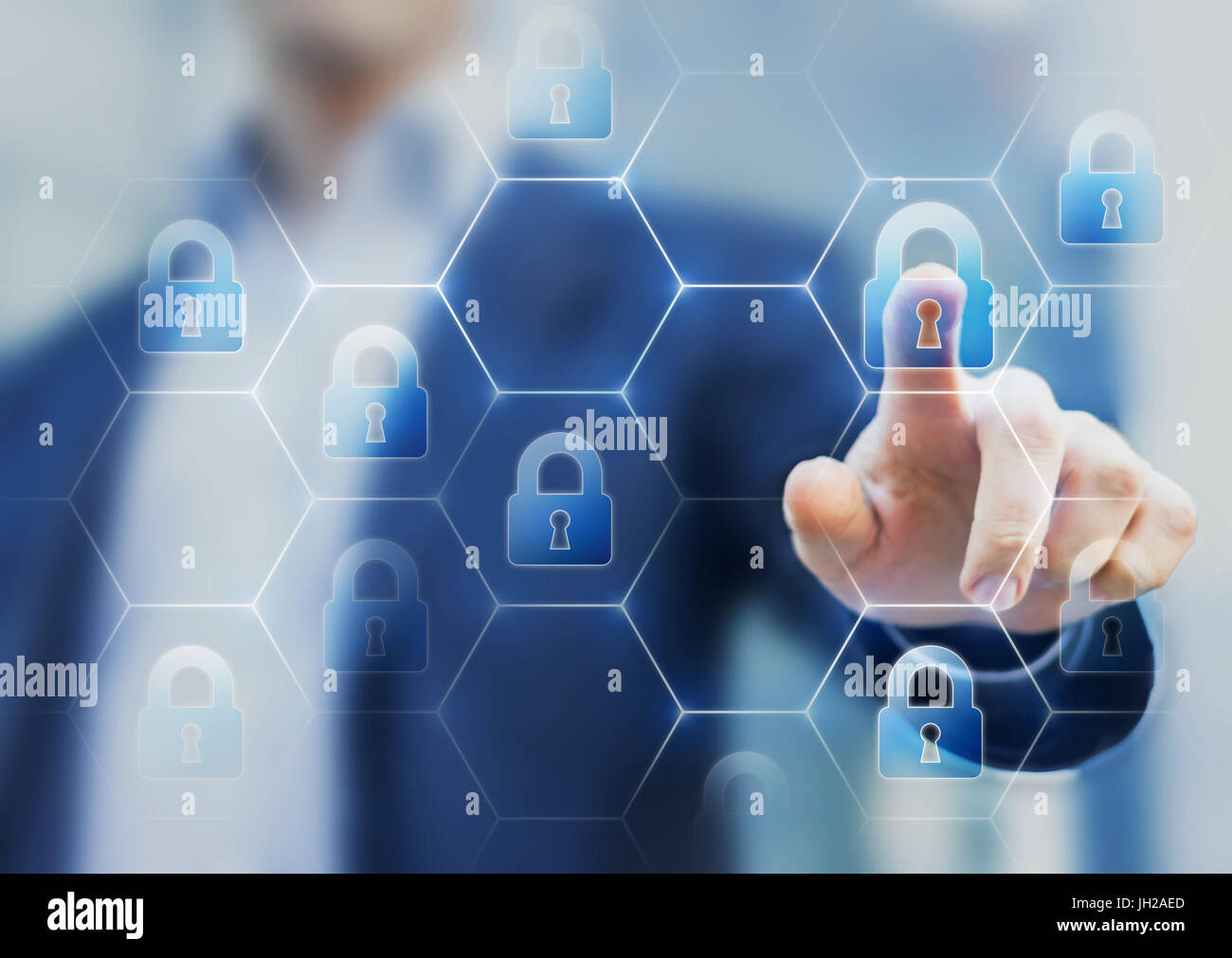 Security consultant touching a network of lock icons on a virtual screen, symbol of cybersecurity on internet and protection against cyber crime Stock Photo