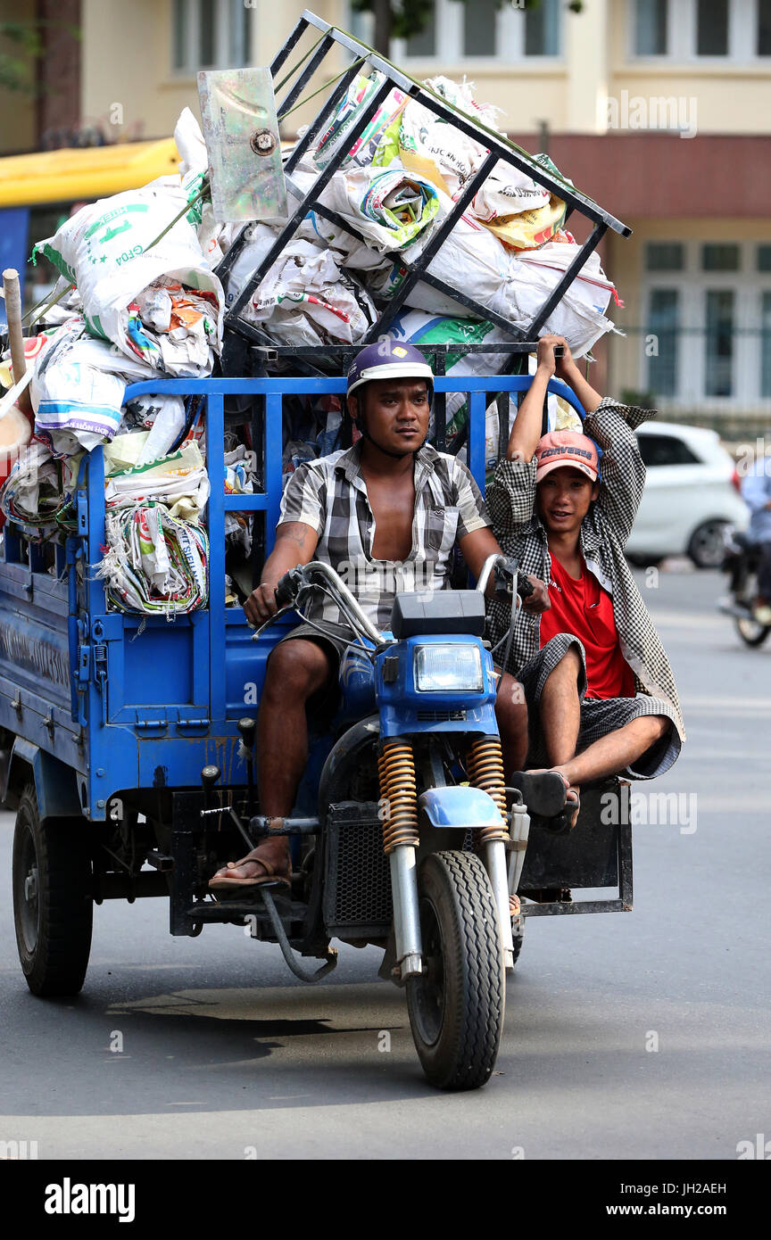 Man riding a motorcycle  with huge packages.  Vietnam. Stock Photo