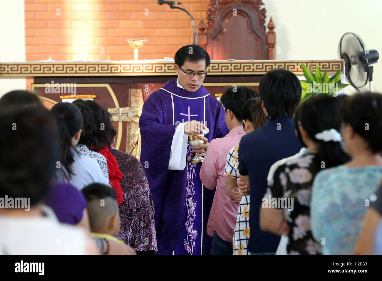 Franciscan missionaries of Mary church.   Sunday morning mass.  Holy communion.  Ho chi Minh City. Vietnam. Stock Photo