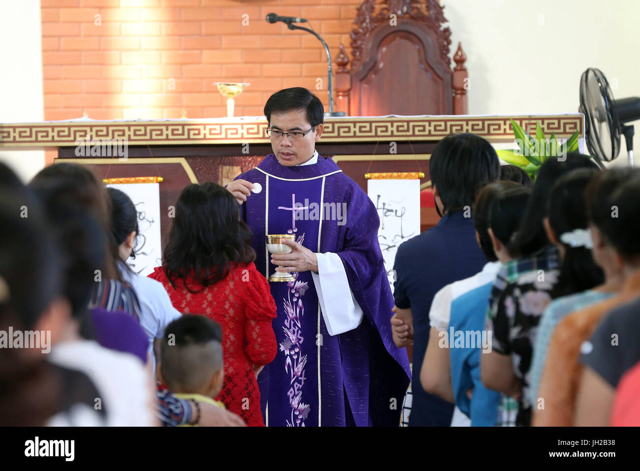 Franciscan missionaries of Mary church.   Sunday morning mass.  Holy communion.  Ho chi Minh City. Vietnam. Stock Photo