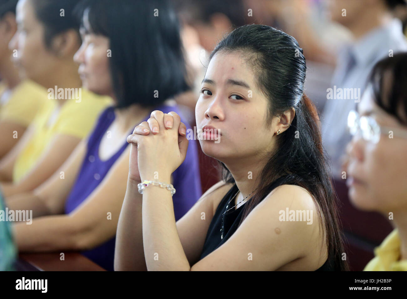 Franciscan missionaries of Mary church.   Sunday morning mass.  Woman praying. Ho chi Minh City. Vietnam. Stock Photo
