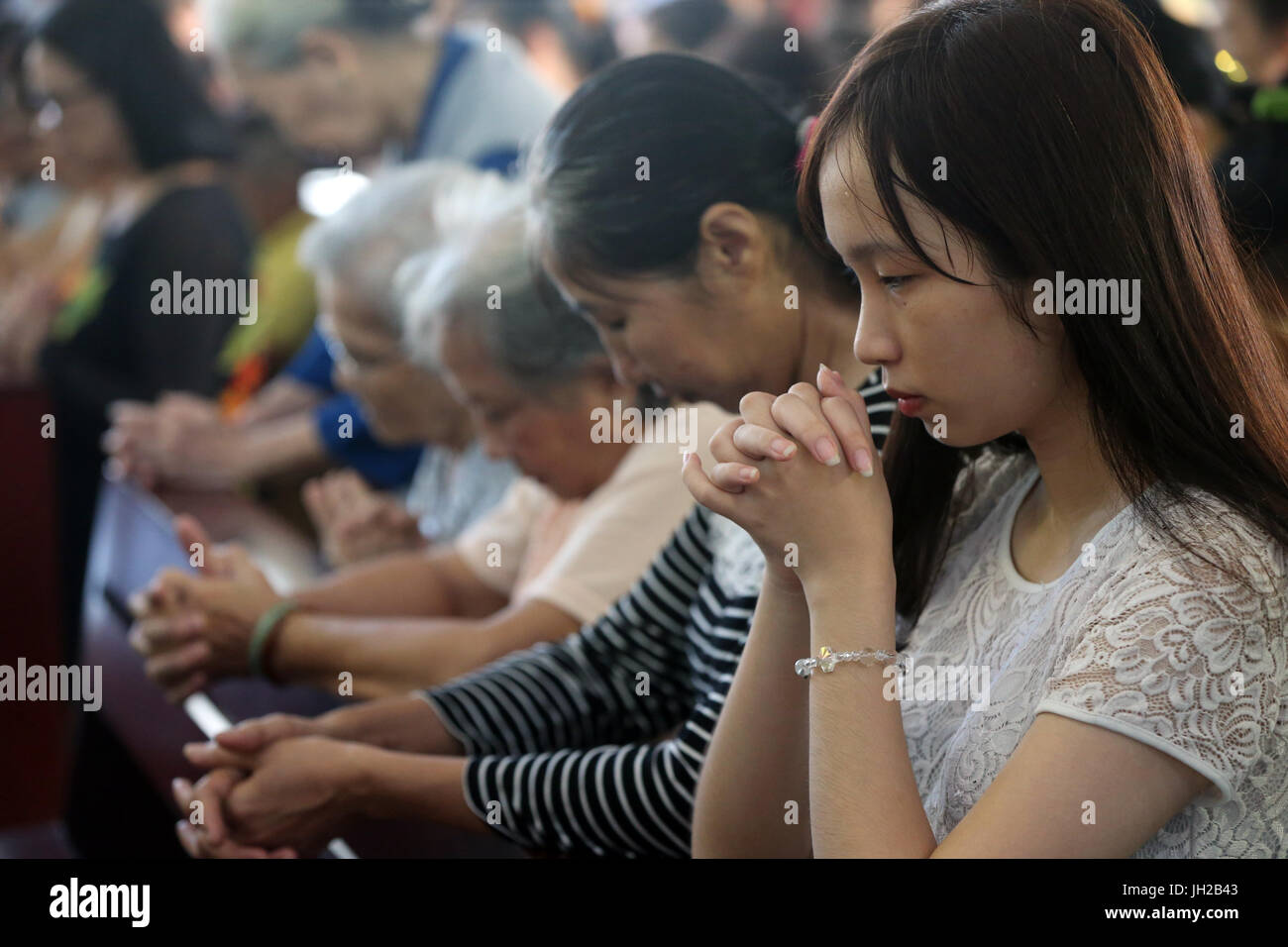 Franciscan missionaries of Mary church.   Sunday morning mass.  Woman praying. Ho chi Minh City. Vietnam. Stock Photo