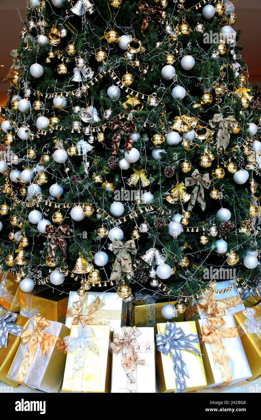 Decorated Christmas tree with presents.  Vietnam. Stock Photo