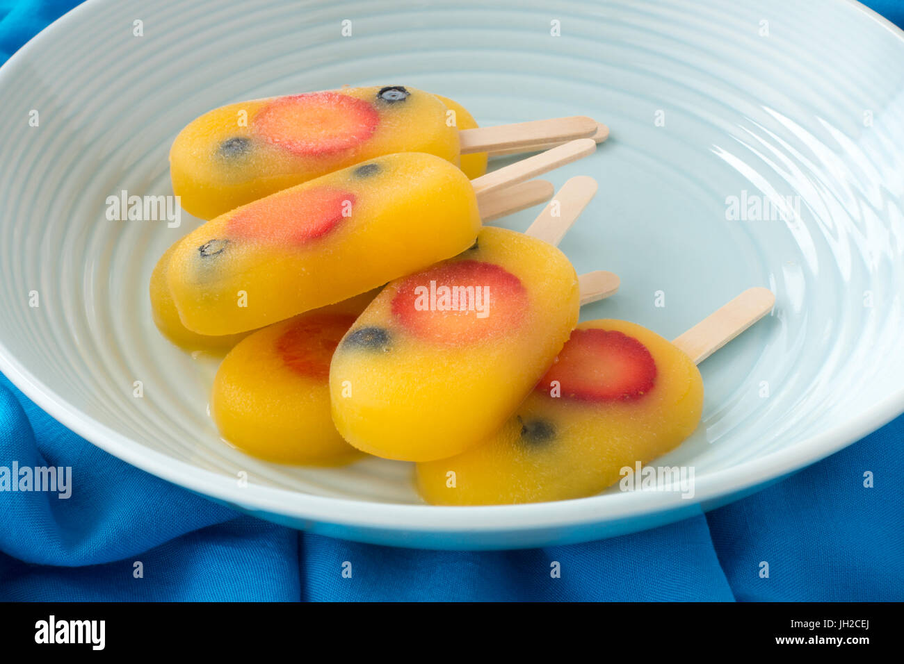 Homemade fruit ice pop, popsicle, ice cream lolly with orange juice