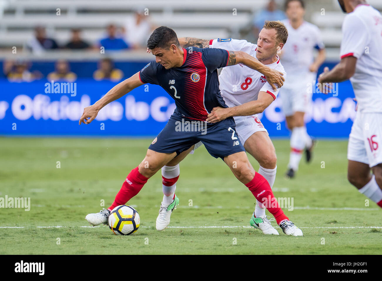 Houston, Texas, USA. 11th July, 2017. Costa Rica defender Johnny Acosta (2) and Canada midfielder Scott Arfield (8) battle for the ball during the 1st half of an international CONCACAF Gold Cup soccer match between Canada and Costa Rica at BBVA Compass Stadium in Houston, TX on July 11th, 2017. The game ended in a 1-1 draw. Credit: Trask Smith/ZUMA Wire/Alamy Live News Stock Photo