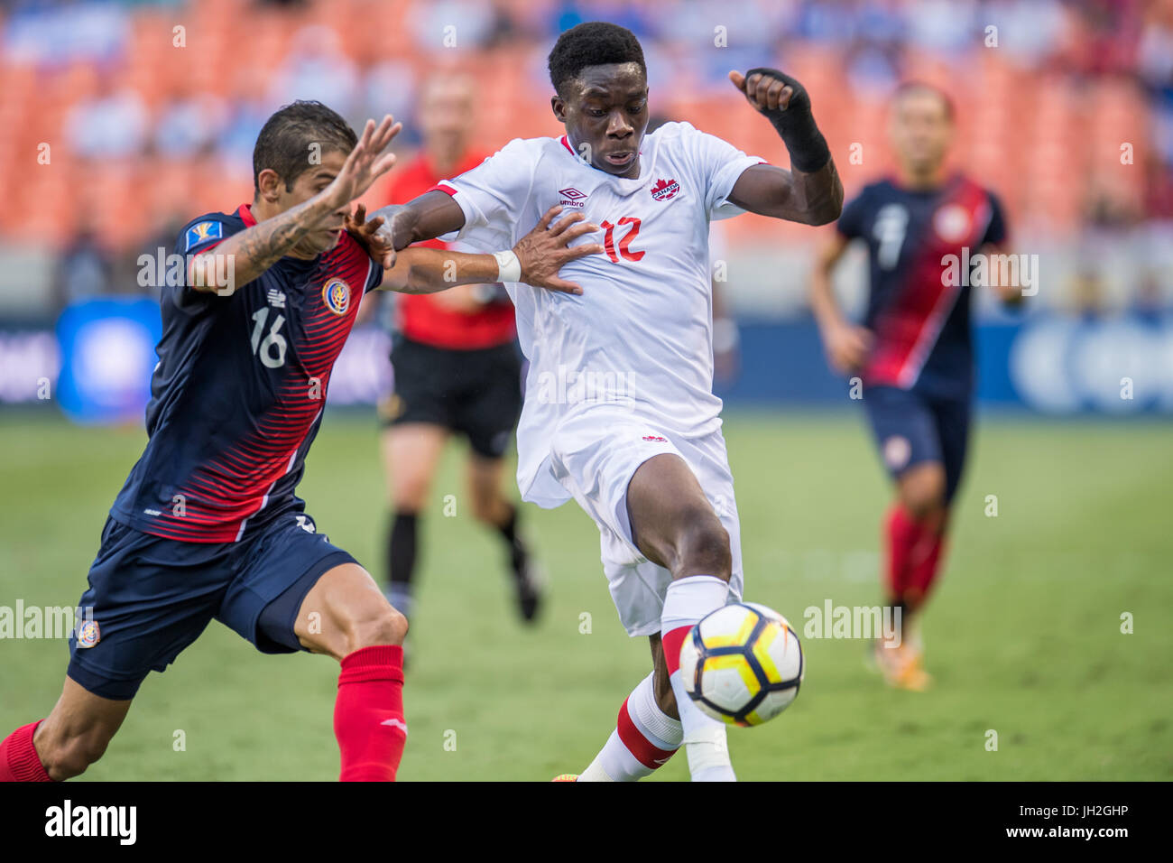 Houston, Texas, USA. 11th July, 2017. Canada midfielder Alphonso Davies (12) and Costa Rica defender Christian Gamboa (16) battle for the ball during the 1st half of an international CONCACAF Gold Cup soccer match between Canada and Costa Rica at BBVA Compass Stadium in Houston, TX on July 11th, 2017. The game ended in a 1-1 draw. Credit: Trask Smith/ZUMA Wire/Alamy Live News Stock Photo