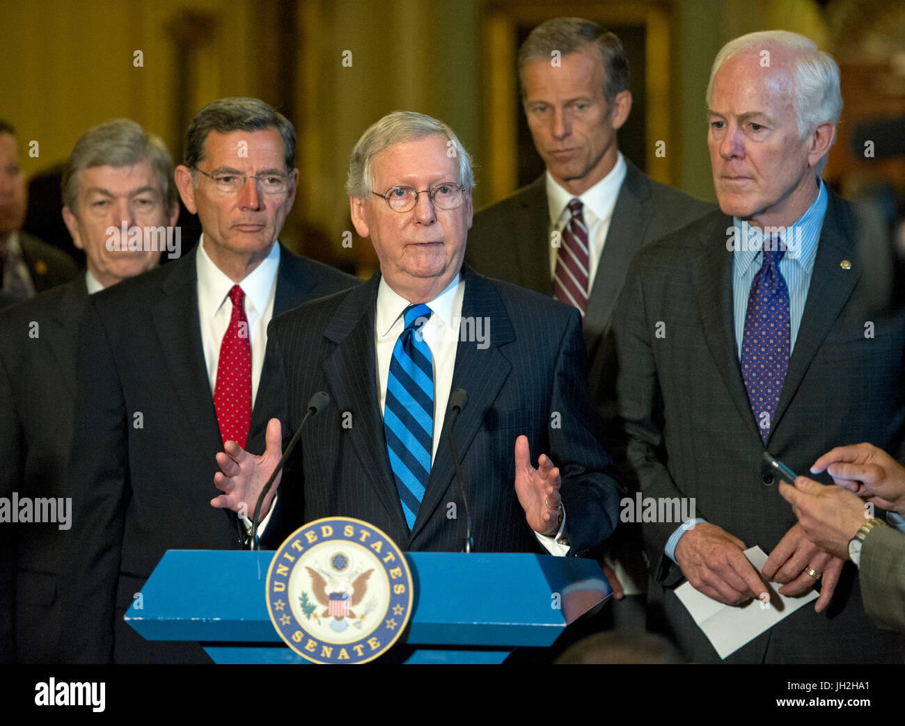 United States Senate Majority Leader Mitch McConnell (Republican of Kentucky), center, speaks to reporters following the Republican Party luncheon in the United States Capitol in Washington, DC on Tuesday, July 11, 2017. From left to right: US Senator Roy Blunt (Republican of Missouri), US Senator John Barrasso (Republican of Wyoming), Leader McConnell, US Senator John Thune (Republican of South Dakota) and US Senator John Cornyn (Republican of Texas). In his remarks, McConnell announced he will keep the Senate in session for the first two weeks of August, delaying their summer recess. Credi Stock Photo