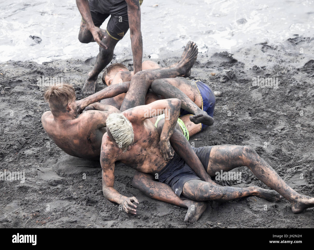 Spanish teenagers fun fighting on beach Stock Photo