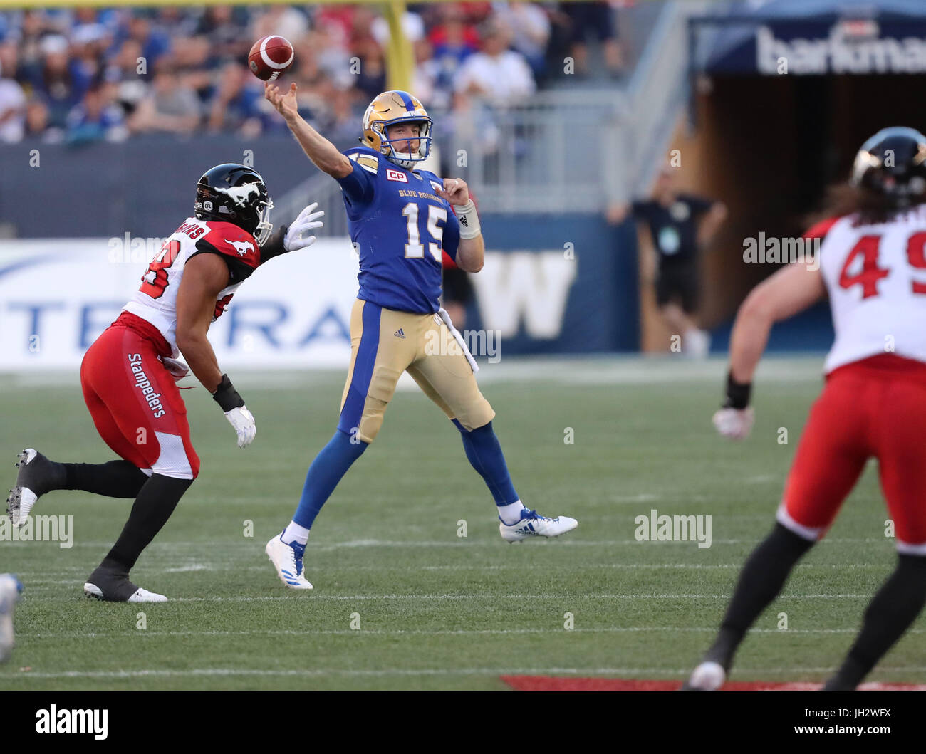Winnipeg, Manitoba, CAN. 7th July, 2017. July 7, 2017; Winnipeg, Manitoba, CAN; Winnipeg Blue Bombers quarterback Matt Nichols (15) prepares to throw the ball as he is pressured by Calgary Stampeders defensive lineman James Vaughters (98) during the first half at Investors Group Field. Mandatory Credit: Bruce Fedyck- Zuma Media Credit: Bruce Fedyck/ZUMA Wire/Alamy Live News Stock Photo