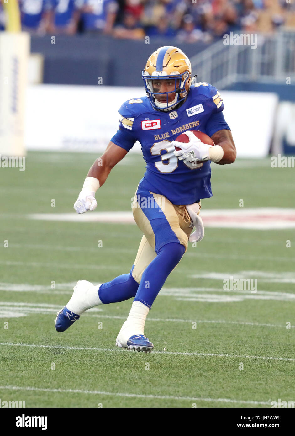 Winnipeg, Manitoba, CAN. 7th July, 2017. July 7, 2017; Winnipeg, Manitoba, CAN; Winnipeg Blue Bombers running back Andrew Harris (33) prepares his run back during the first half against the Calgary Stampeders at Investors Group Field. Mandatory Credit: Bruce Fedyck- Zuma Media Credit: Bruce Fedyck/ZUMA Wire/Alamy Live News Stock Photo