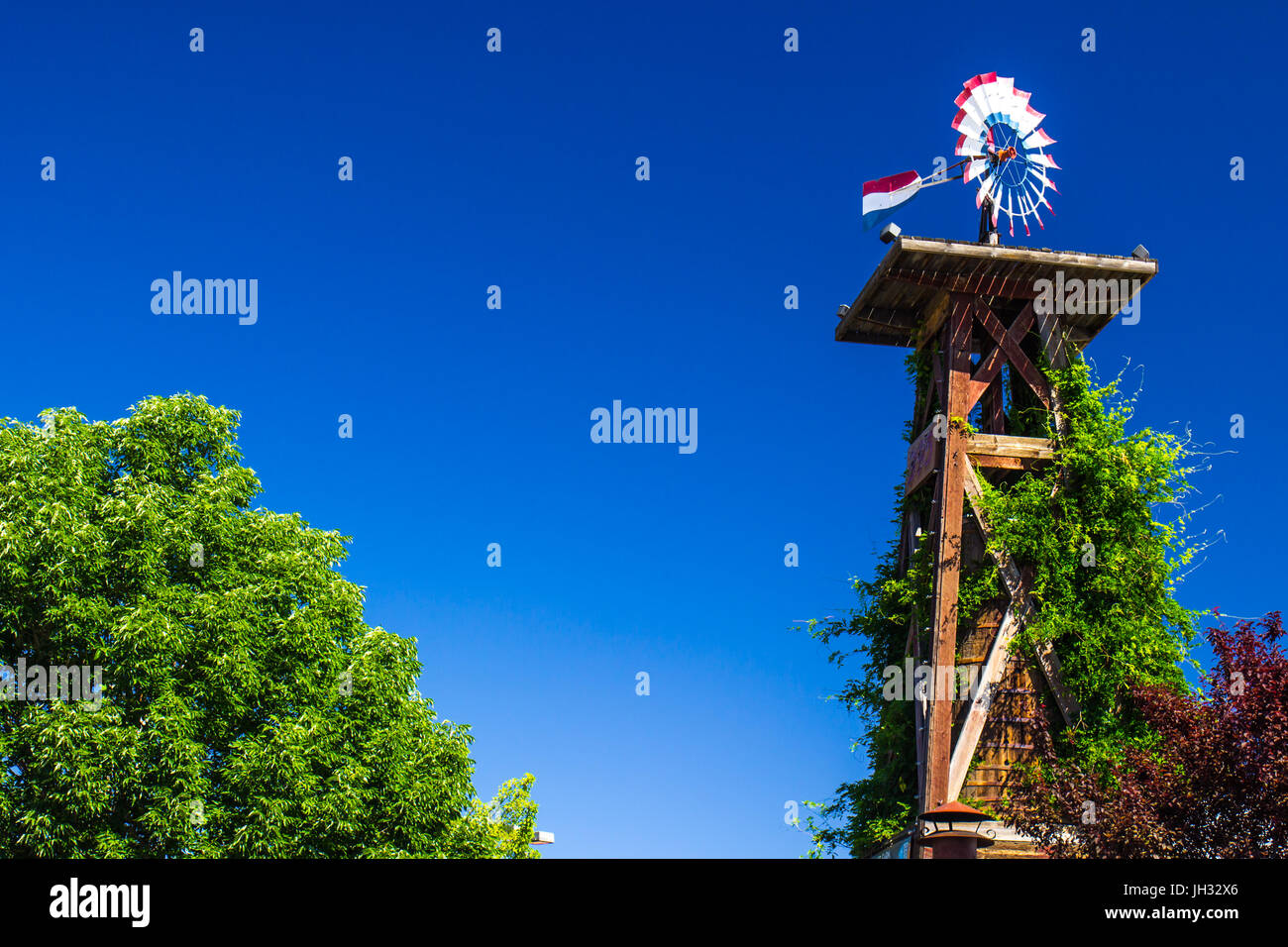 Wooden Tower with Water Tank & Patriotic Weather Vane Stock Photo