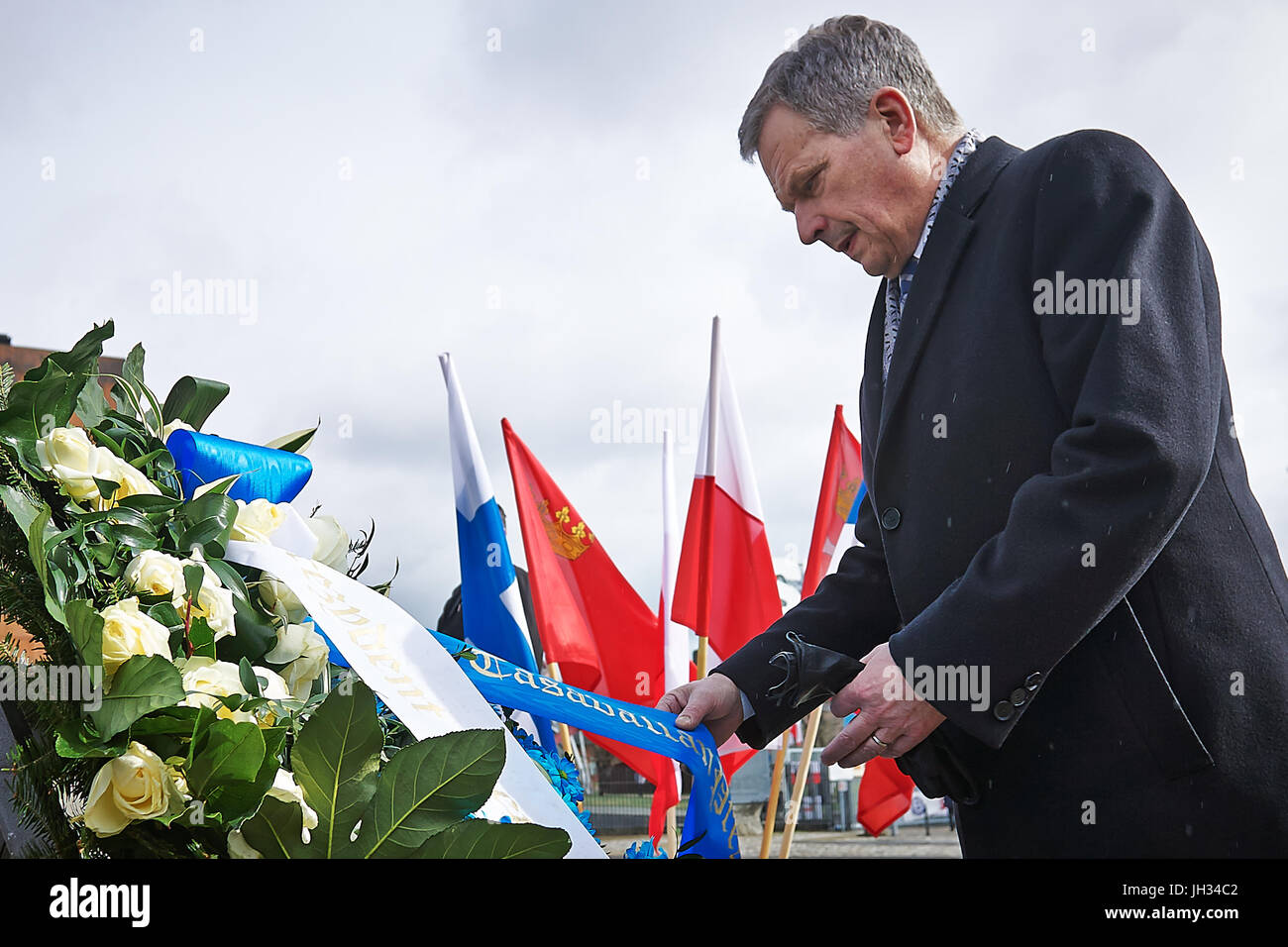 President of the Republic of Finland Sauli Niinistö laid flowers under the 1970 Fallen Shipyard Workers Monument in Gdansk, Poland, 01 April 2015. Stock Photo
