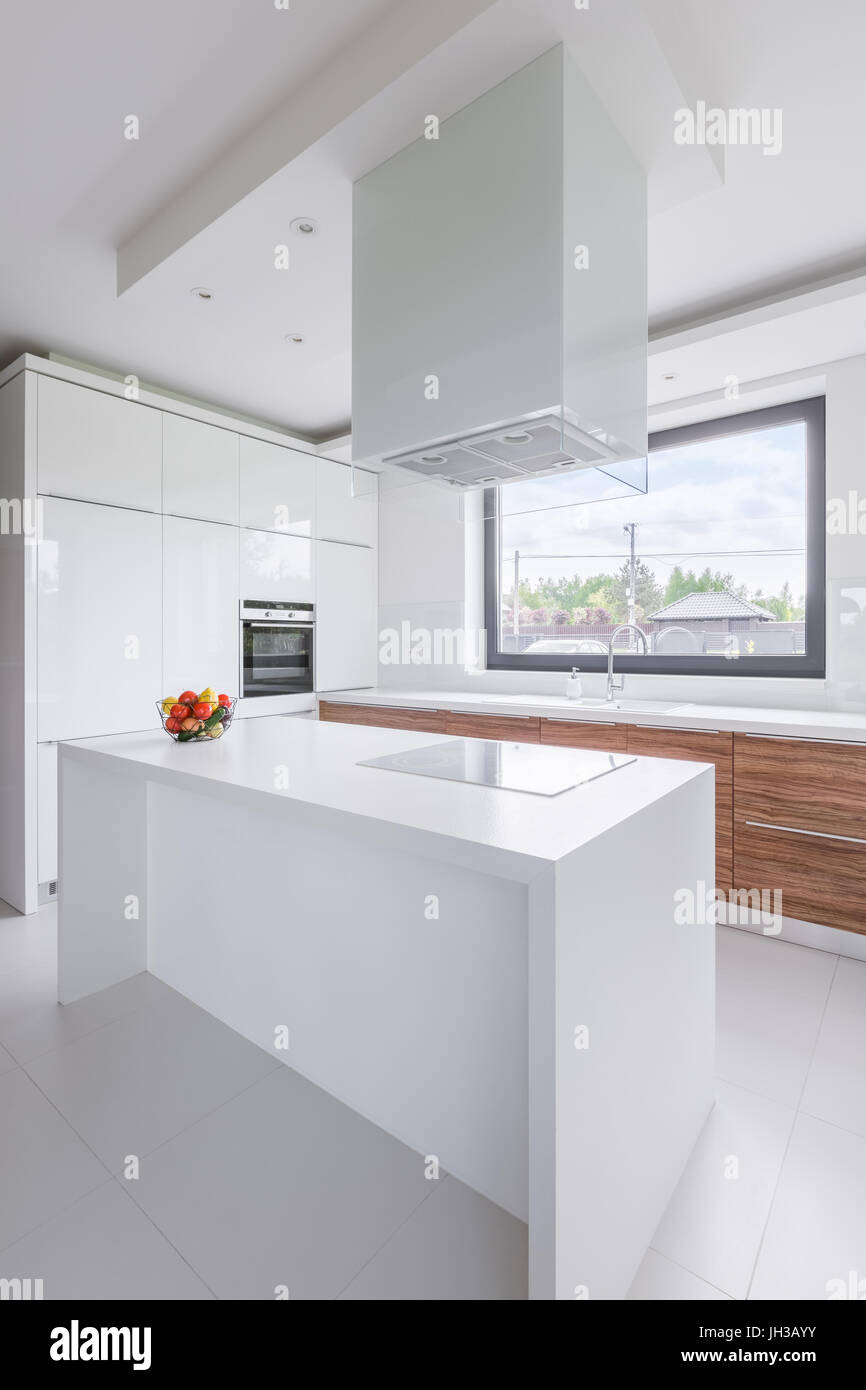 New design white kitchen with island, window and exhaust hood Stock ...