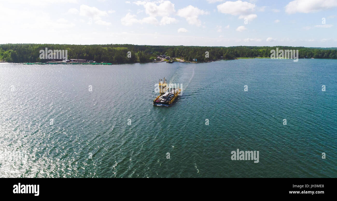 Aerial view following a cable ferry floating between korppo and Nagu ...