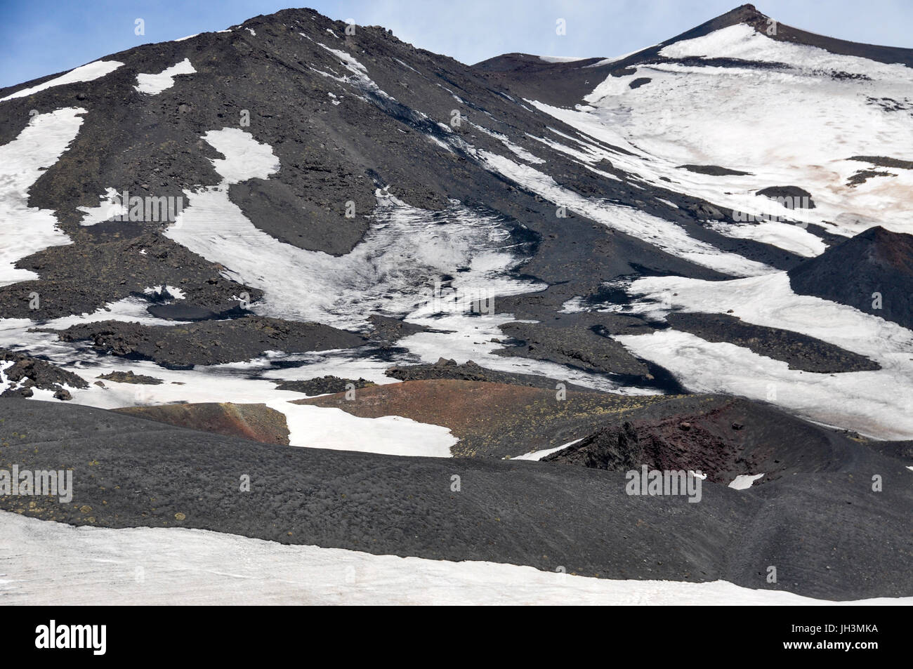 Snow and lava rock on the volcano, Mount Etna, Sicily, Italy. Stock Photo