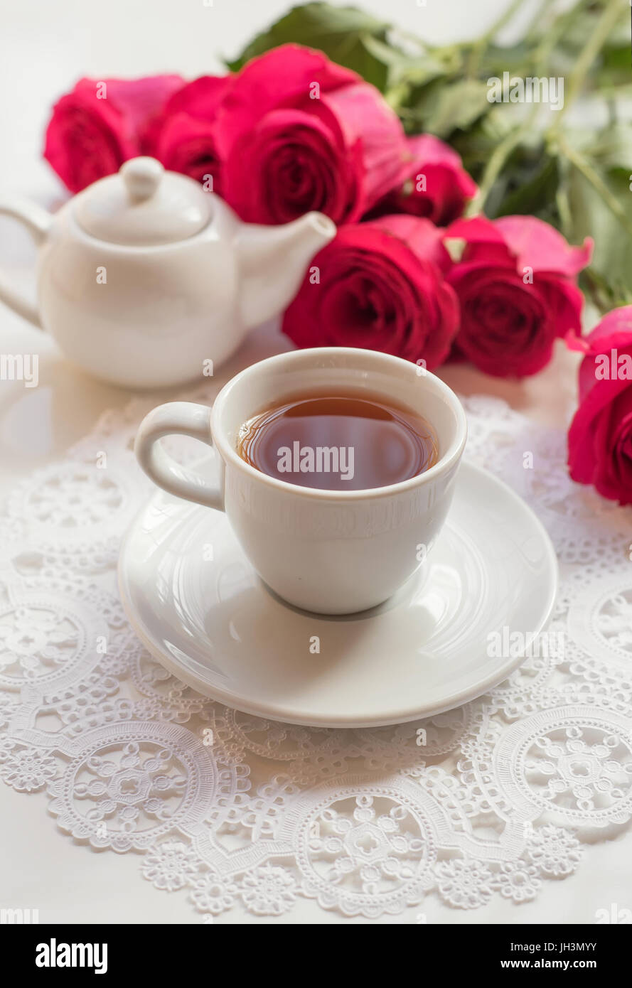 Afternoon tea and roses on white table Stock Photo - Alamy