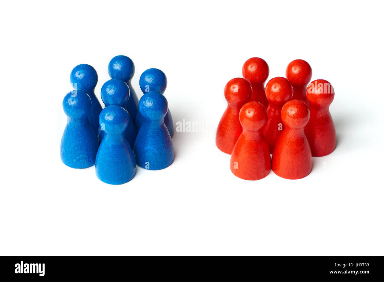 Game figures as a symbol for two groups of people. Concept for teamwork or challange. Isolated on white background. Stock Photo